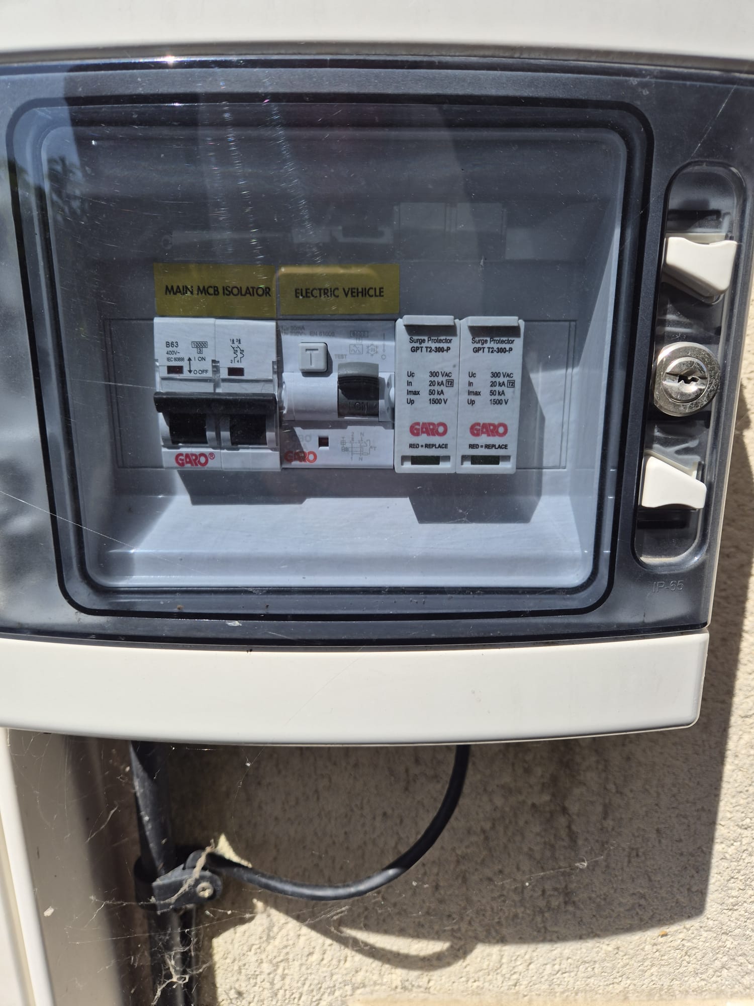 Outdoor EV charger supply unit with isolator and surge protection.